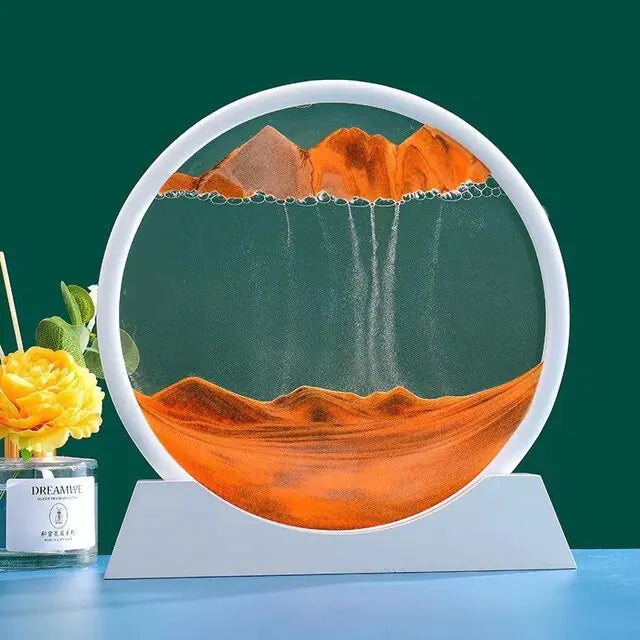 Round decorative piece with mountain design on a stand, next to a candle and flowers.