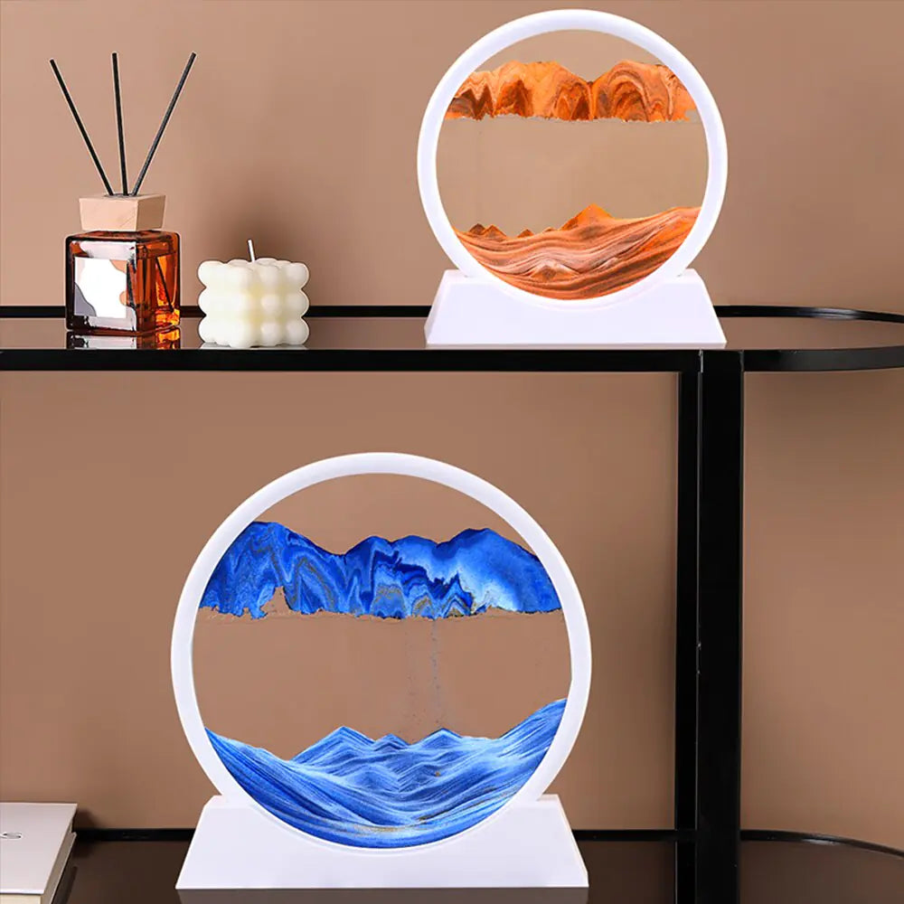 Two circular landscape lamps with orange and blue designs on a table against a brown wall.