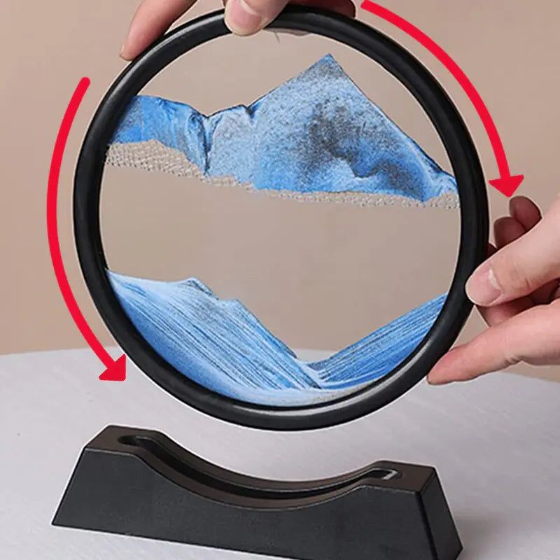 Circular device displaying a mountainous landscape with hands holding it open.